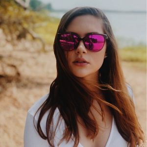 Woman Posing by the Beach in 'Olu 'Olu sunglasses
