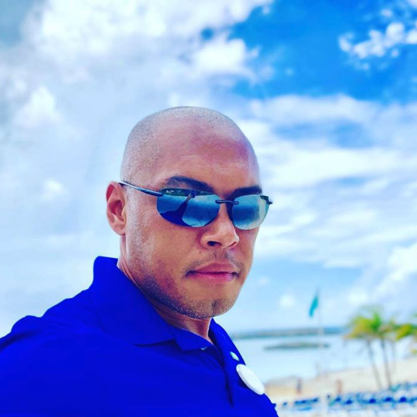 Man at beach wearing rimless Maui Jim sunglasses