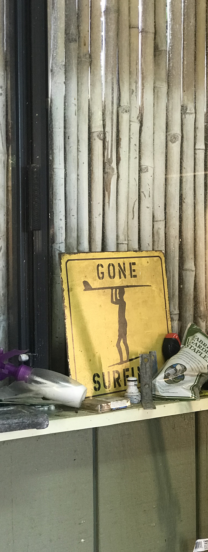 Gone Surfing sign with bamboo wall