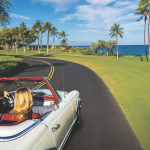 Couple in White Convertible by Ocean