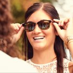 Woman trying on Kawika sunglasses