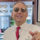 Eye Dr. smiles and points at the camera while wearing bronze prescription sunglasses