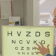 Eye Dr. stands in front of a board of letters of various size