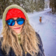 Woman in front of winter scene wearing PolarizedPlus2® sunglasses