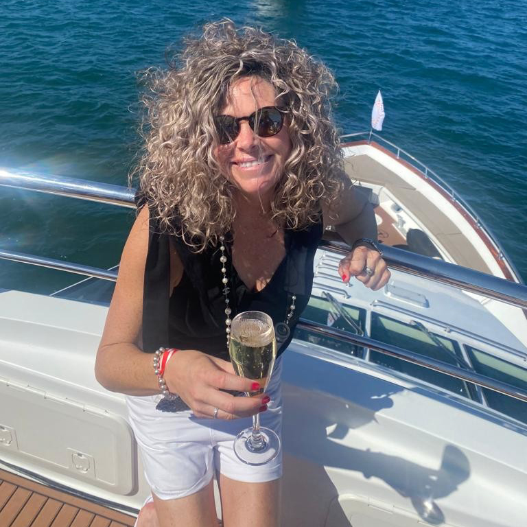 A woman on a boat holding a glass