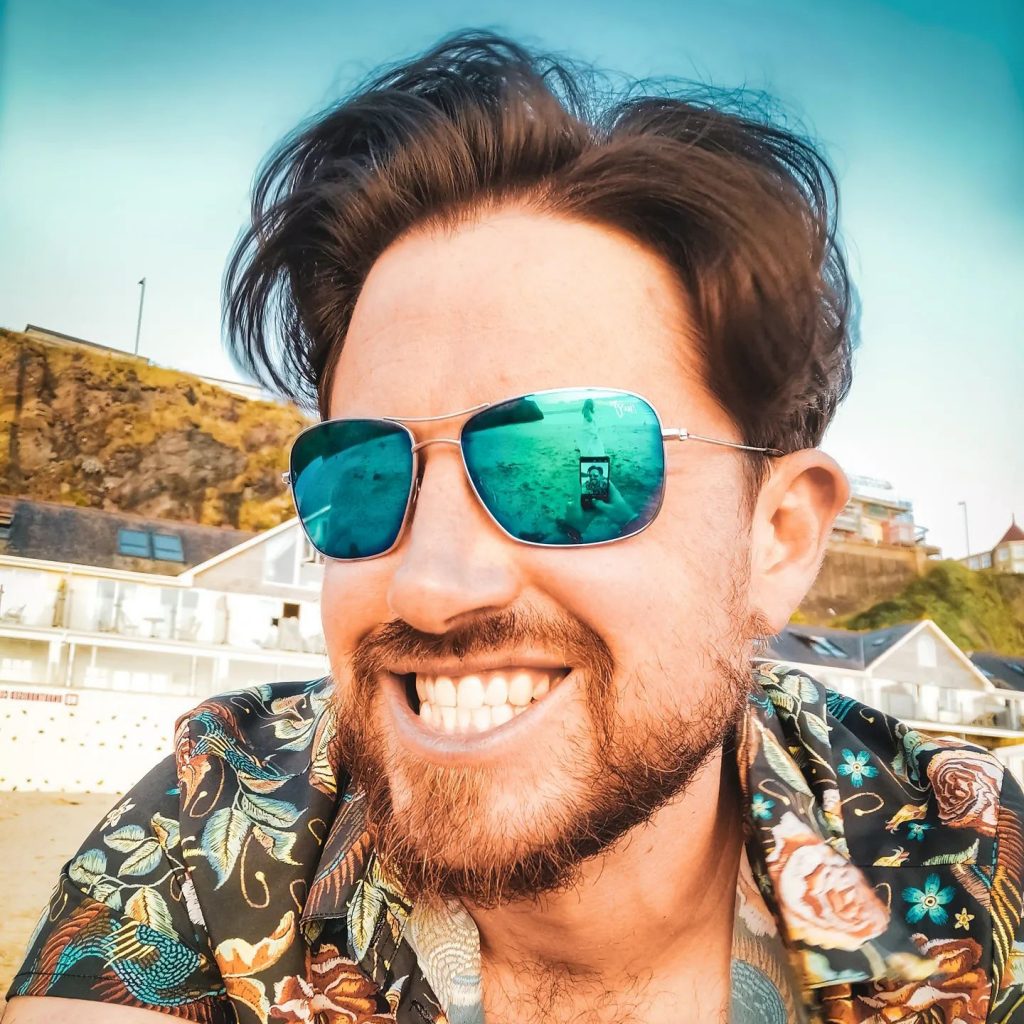 A man in sunglasses smiling