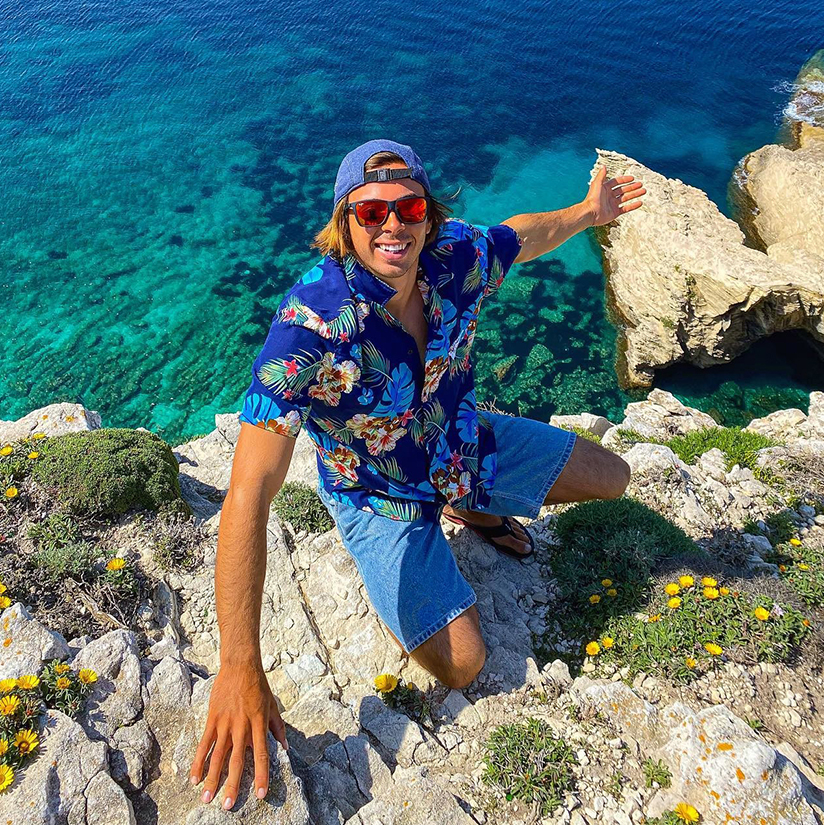 man posing next to a lake