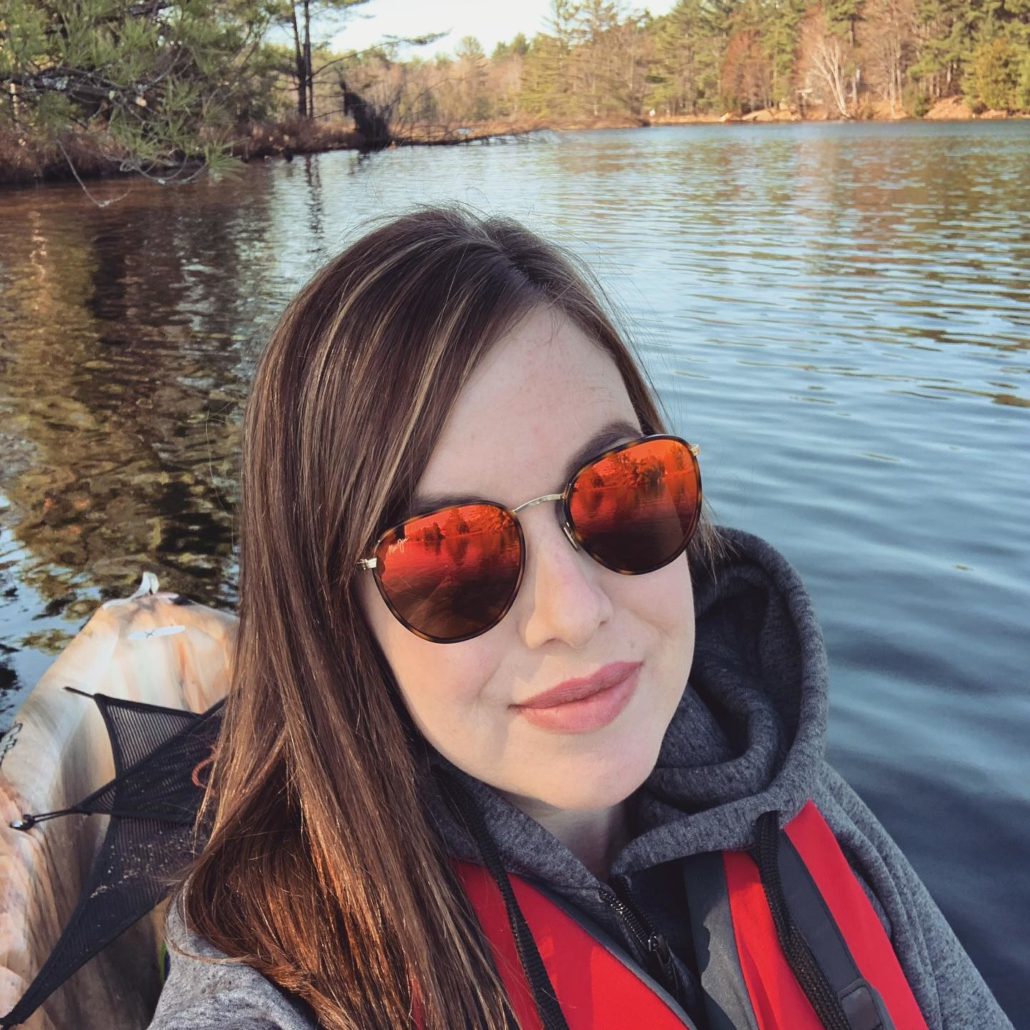 Woman wearing a coat in a boat on the water