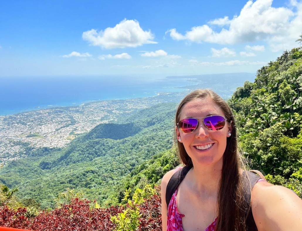 Woman in pink aviator with mountain view