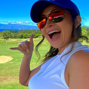 A woman in a cap on a golf course