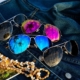 Various aviator sunglasses on a jean background