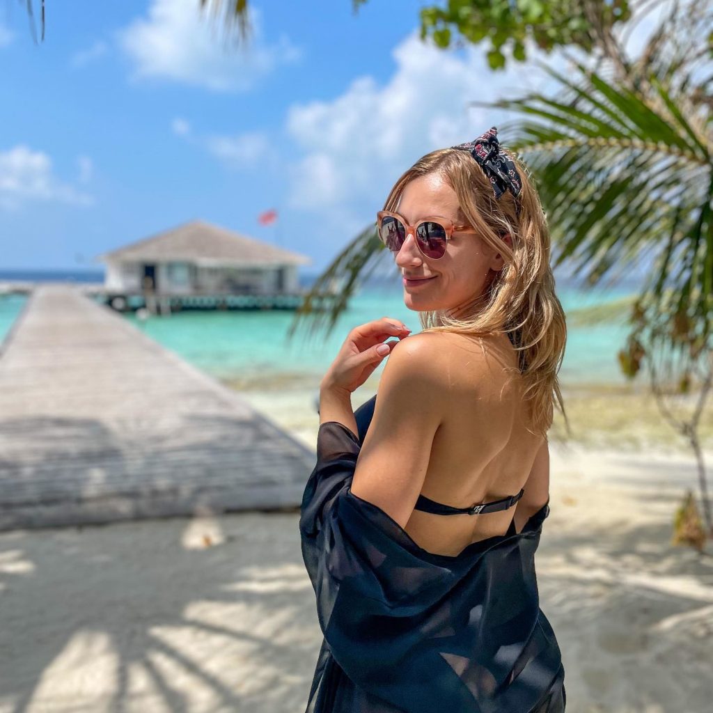 A woman posing near a beach